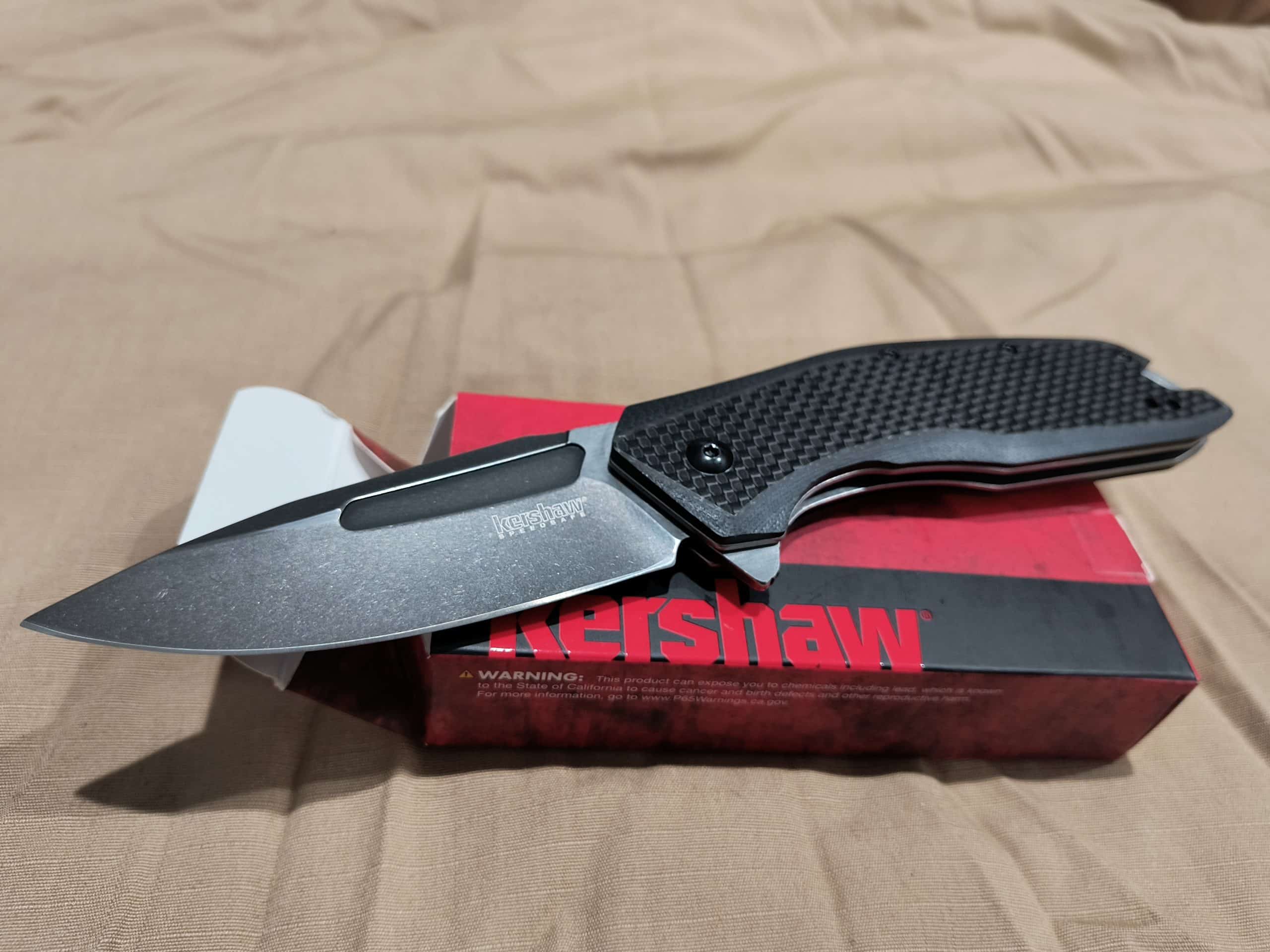Kershaw Flourish Pocket Knife (3935); 3.5-Inch Blackwash Clip Point Blade With Black Carbon Fiber Handle; Features SpeedSafe Assisted Opening, Flipper, Lanyard Hole And Reversible Pocket Clip; 5.3 OZ.
